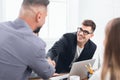 Boss congratulating on promotion male subordinate at meeting Royalty Free Stock Photo