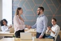 Boss handshaking successful female employee congratulating with Royalty Free Stock Photo