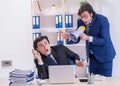 Boss and his male assistant working in the office Royalty Free Stock Photo