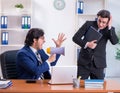 Boss and his male assistant working in the office Royalty Free Stock Photo