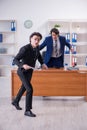 Boss and his male assistant working in the office Royalty Free Stock Photo