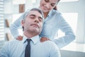 Satisfied employee having pleasant massage at work