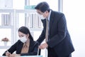 Boss and secretary wearing mask for protecting virus