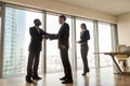 Boss shaking hand to new company worker in cabinet Royalty Free Stock Photo