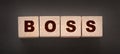 The boss sign on a wooden cubes on black. Business owner concept