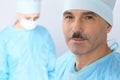 Boss surgeon is examining the operation while medical team are busy of patient. Medicine, healthcare and emergency in Royalty Free Stock Photo