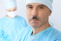 Boss surgeon is examining the operation while medical team are busy of patient. Medicine, healthcare and emergency in Royalty Free Stock Photo