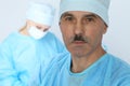 Boss surgeon is examining the operation while medical team are busy of patient. Medicine, healthcare and emergency in Royalty Free Stock Photo