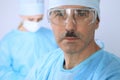 Boss surgeon is examining the operation while medical team are busy of patient. Medicine, healthcare and emergency in Royalty Free Stock Photo