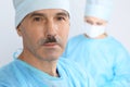 Boss surgeon is examining the operation while medical team are busy of patient. Medicine, healthcare and emergency in Royalty Free Stock Photo