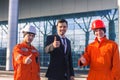 Boss and team of young engineers showing thumbs up