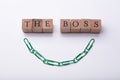 The Boss Text On Wooden Blocks Near Green Paperclip Chain