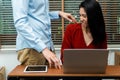 Boss touching shoulder of a young female employee in office at workplace. She is uncomfortable and afraid of sexual inappropriate Royalty Free Stock Photo