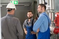 Boss with two worker in factory Royalty Free Stock Photo