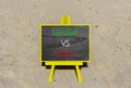 Boss vs leader symbol. Concept words Boss vs versus leader on beautiful black chalk blackboard. Beautiful sand background.