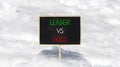 Boss vs leader symbol. Concept words Boss vs versus leader on beautiful black chalk blackboard. Beautiful snow background.