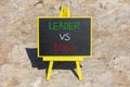 Boss vs leader symbol. Concept words Boss vs versus leader on beautiful black chalk blackboard. Beautiful stone background.