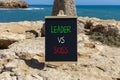 Boss vs leader symbol. Concept words Boss vs versus leader on beautiful black chalk blackboard. Beautiful stone sea sky background