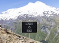 Boss vs leader symbol. Concept words Boss vs versus leader on beautiful black chalk blackboard. Beautiful mountain Elbrus