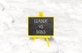 Boss vs leader symbol. Concept words Boss vs versus leader on beautiful black chalk blackboard. Beautiful snow background.