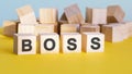 Boss word construction with letter blocks and a shallow depth of field