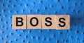 Boss word letters on a wooden cubes put on red leather. Business leader concept Royalty Free Stock Photo