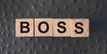 Boss word letters on a wooden cubes put on red leather. Business leader concept Royalty Free Stock Photo