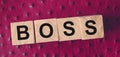 Boss word letters on a wooden cubes put on red leather. Business leader concept Royalty Free Stock Photo