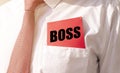 Boss word on paper in pocket of CEO. Business leader concept