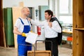 Boss and worker in a carpenter's workshop Royalty Free Stock Photo