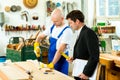 Boss and worker in a carpenter's workshop Royalty Free Stock Photo