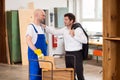 Boss and worker in carpenter's workshop Royalty Free Stock Photo