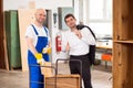 Boss and worker in carpenter's workshop Royalty Free Stock Photo