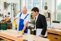 Boss and worker in carpenter's workshop Royalty Free Stock Photo