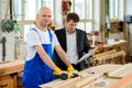 Boss and worker in a carpenter's workshop Royalty Free Stock Photo