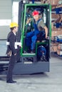 Boss and worker in lift truck