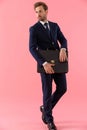 Bossy businessman holding a briefcase and looking away