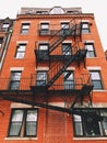 Boston brick red apartments buildings exterior with fire escape ladder Royalty Free Stock Photo