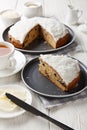 Boston bun, also known as a Sally Lunn, is a large spiced bun with a thick layer of coconut icing closeup. Vertical Royalty Free Stock Photo