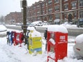 Boston, MA/USA-January 22 2014: Newspaper and magazine dispensers/boxes under snow in a snowy day