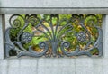 Stone wall with wrought iron floral design