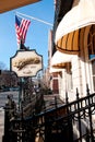 Boston, USA - February 12, 2012: Entrance to the Cheers bar in Boston, with traditional poster and American flag Royalty Free Stock Photo