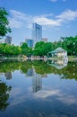 Frog Pond in Boston Common with reflection of buildings and locals walkings and resting by the water