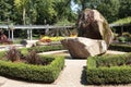 botanical garden with waterfall fountain rock structure bushes paths pathways. p