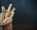 Codonopsis Root in basket on brown wooden table with black background. copy space. Royalty Free Stock Photo