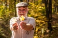 Botanist examine herbs. Curiosity to botany. Explore world around. Pensioner hiking in forest on sunny autumn day. Old Royalty Free Stock Photo