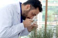 Botanist scientist holds magnifying glass to explore rosemary, finds pest in an organic plant, biological researcher man does