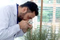 Botanist scientist holds magnifying glass to explore rosemary, finds pest in an organic plant, biological researcher man does