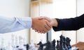 Both businessmen played chess to increase their business skills and held hands together for success