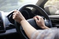 Both hands of woman wearing a wheel driving right hand drive car